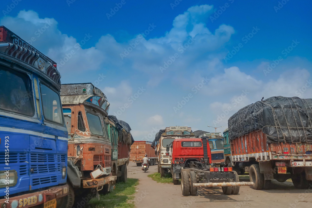 PETRAPOLE, WEST BENGAL , INDIA - JUNE 2ND 2018 : Goods carriage trucks at Indian side of international border between India and Bangladesh . Benapole is Bangladesh side.