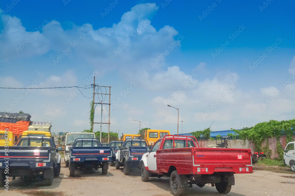PETRAPOLE, WEST BENGAL , INDIA - JUNE 2ND 2018 : Goods carriage trucks at Indian side of international border between India and Bangladesh . Benapole is Bangladesh side.