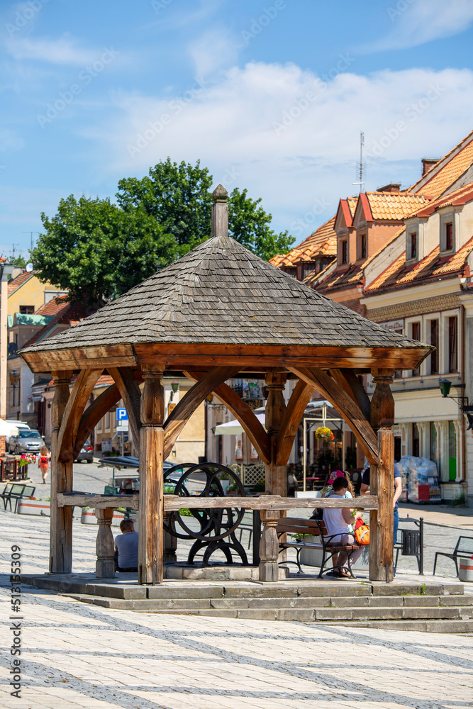 View on market with  old wooden well, Sandomierz, Poland