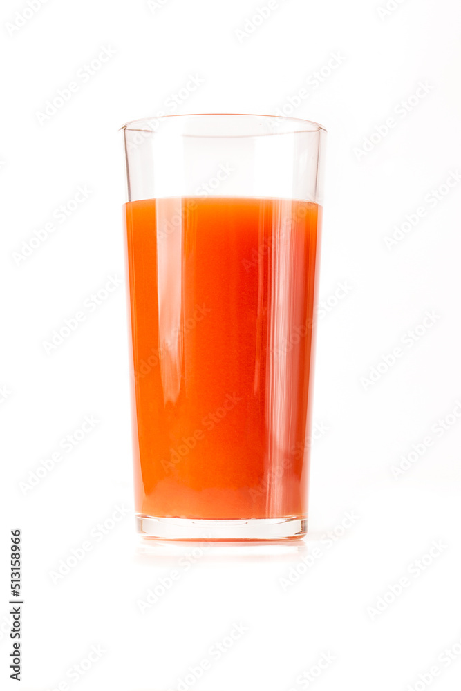 Tomato juice in a tall glass glass on a white background. Tomato juice in a tall glass glass on a white background.