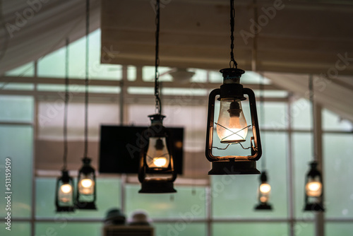 Vintage style ceiling lighting lamp is glowing in warming light shade. Interior decoration for living room object photo. Selective focus.