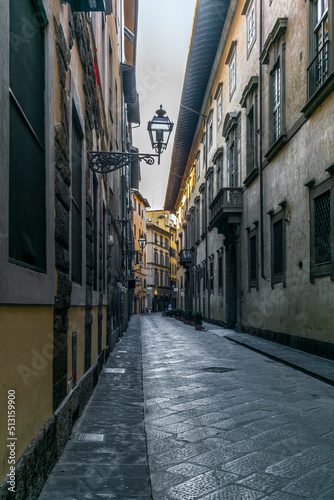 Fototapeta Naklejka Na Ścianę i Meble -  An empty alley in Florence in Italy early in the morning