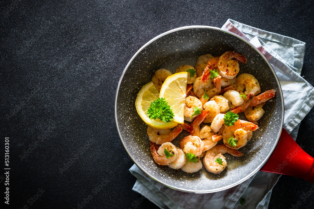 Frying shrimps with lemon in the frying pan. Frying shrimps with lemon in the frying pan.