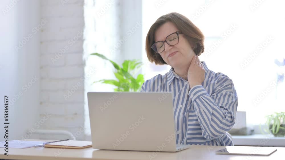 Senior Woman having Neck Pain while using Laptop Senior Woman having Neck Pain while using Laptop