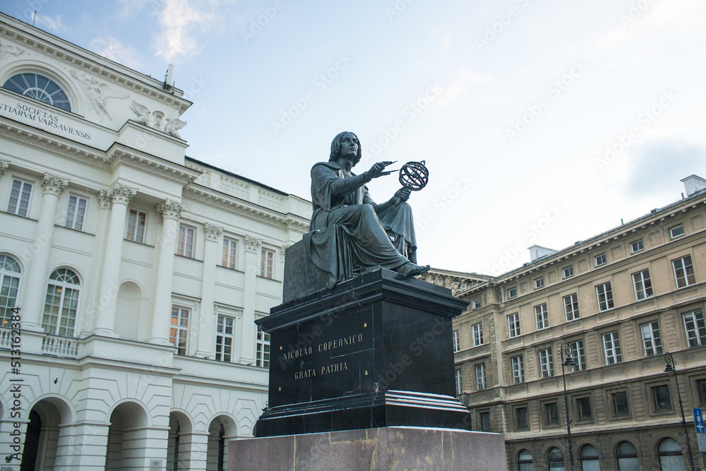 Monument to Nicholas Copernicus (1830) by Bertel Thorvaldsen holding a compass and armillary sphere in front of Academy of Science in Warsaw 