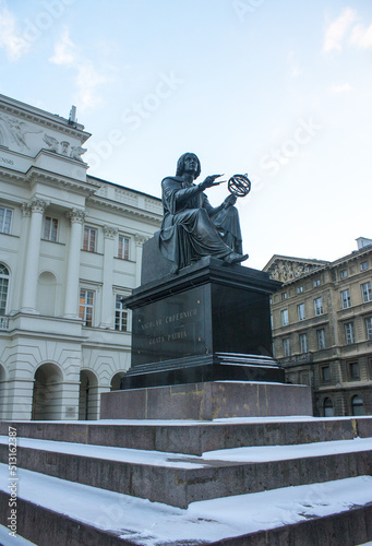 Monument to Nicholas Copernicus (1830) by Bertel Thorvaldsen holding a compass and armillary sphere in front of Academy of Science in Warsaw
