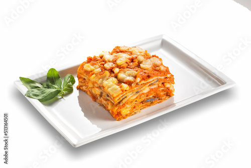 Rectangular dish with eggplant parmigiana with tomato cheese and basil leaves