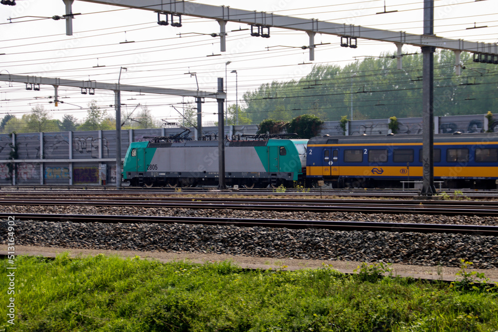 Fototapeta premium Traxx locomotive with container freight at railroad in Barendrecht