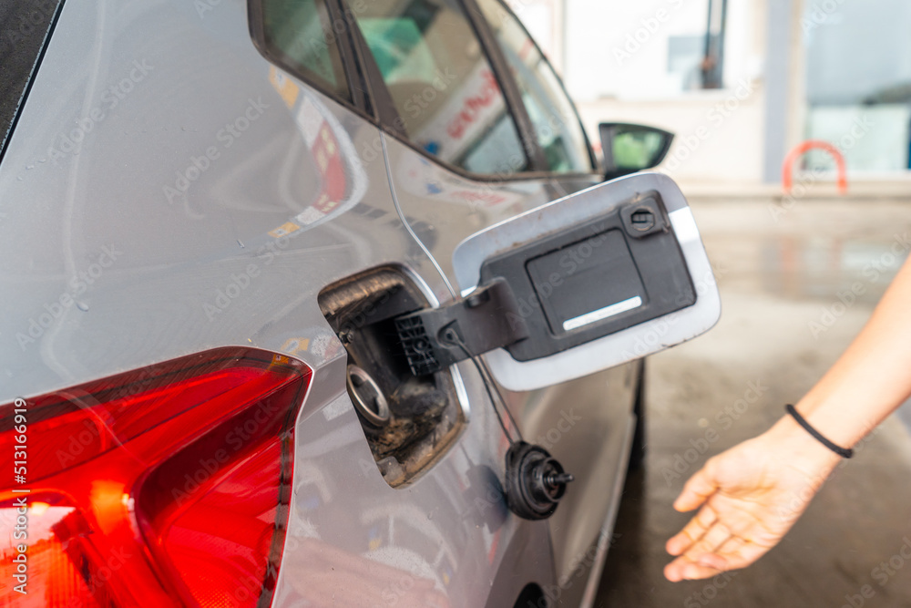 Refueling gasoline at the gas station. gray car Refueling gasoline at the gas station. gray car
