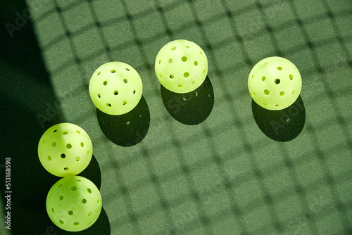 Pickelballs with net shadow on court