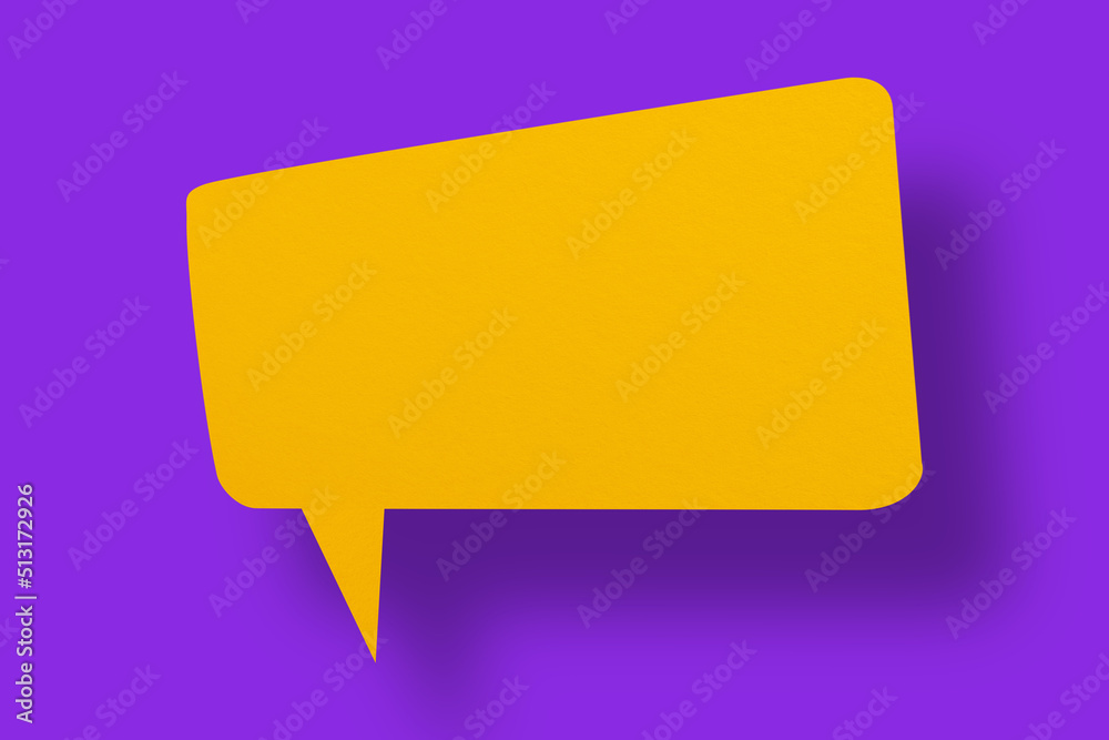 Speech balloon shaped yellow paper against a purple background. Speech balloon shaped yellow paper against a purple background.