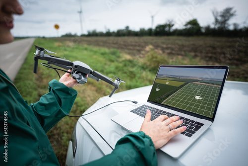 Farmer with laptop and drone on the field. Smart farming and agriculture digitalization	