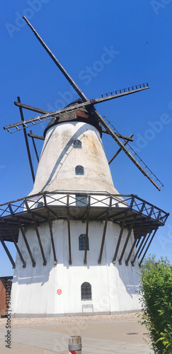 Old Danish wind mill with wings and small windows