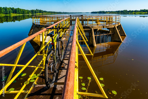 Bicycle on the yellow spilway of river dam