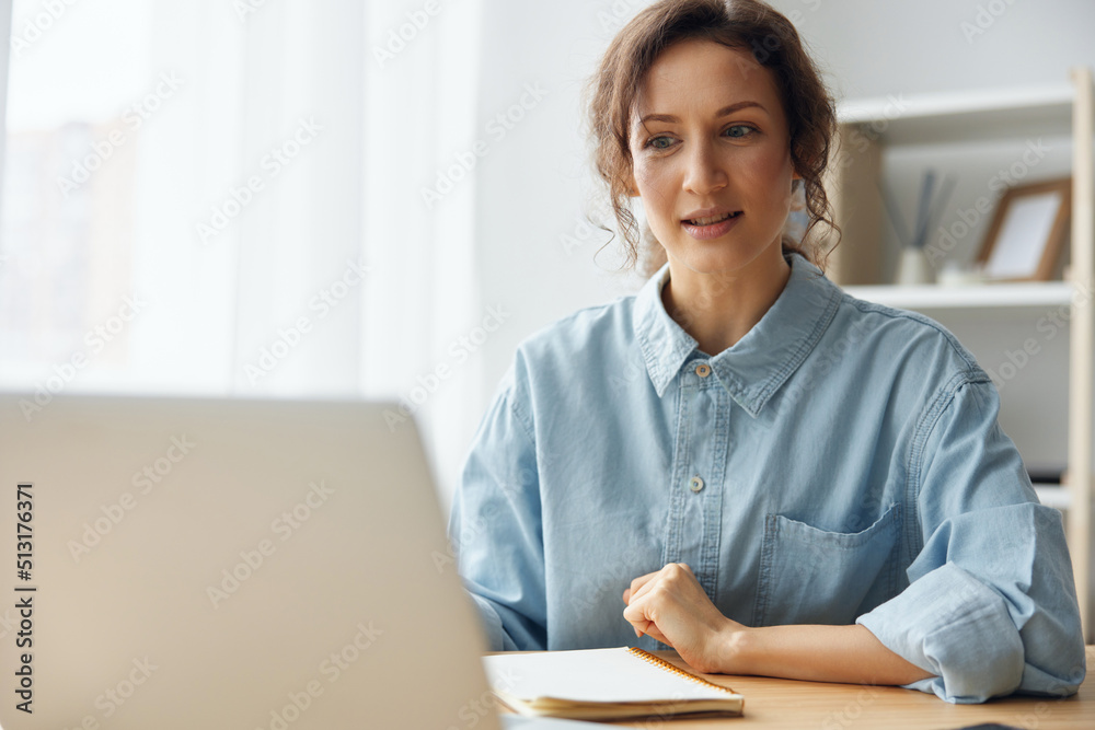Candidate on vacant place answering question of hr in online meeting using laptop. Curly awesome cheerful attentive woman interested listens to employer about conditions of new job at video call Candidate on vacant place answering question of hr in online meeting using laptop. Curly awesome cheerful attentive woman interested listens to employer about conditions of new job at video call