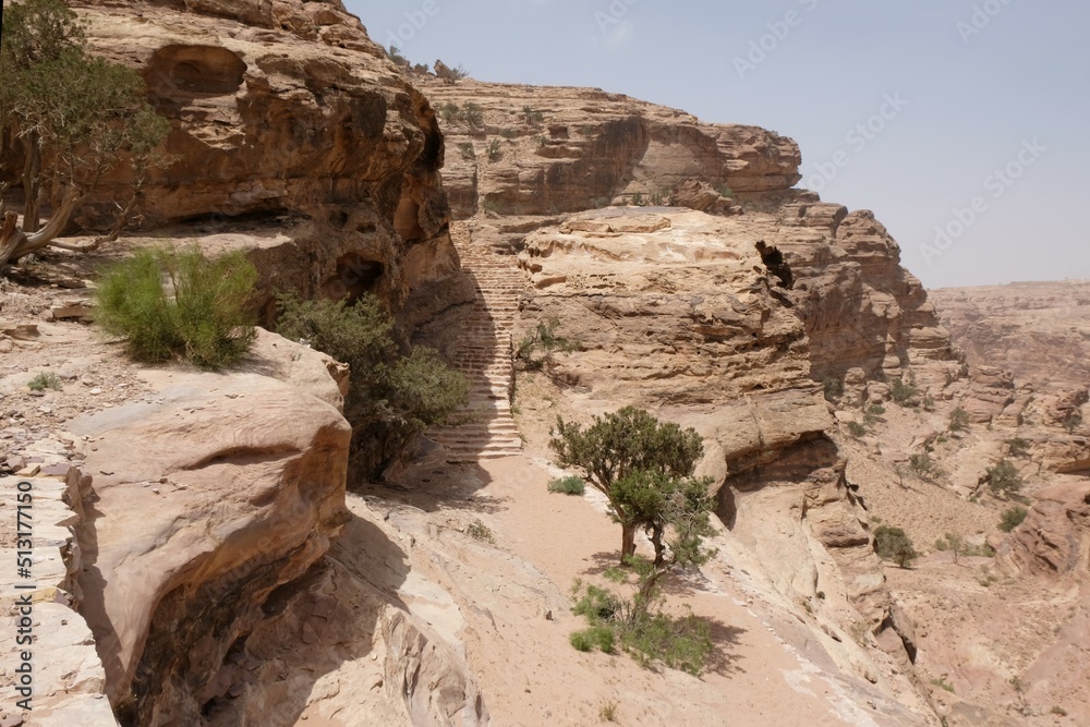 Wonderful mountain views on the Jordan Trail from Little Petra (Siq al-Barid) to Petra. Silhouettes of hiking people on stone stairs. Jordan, Hashemite Kingdom of Jordan 