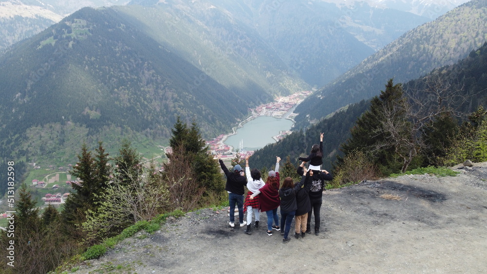 teammates are on nature vacation with their lovers. Taking pictures with drone