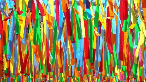 decorative multicolor ribbons waving in the wind at city street holiday, festival or carnival. City festival background