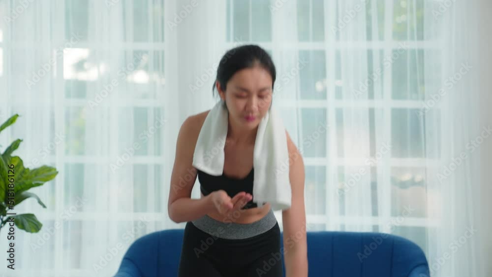 Sporty asia woman taking medicine and drink water, Female takes one pill with water, Biologically active additives. healthy eating. Girl resting after exercise workout. Dietary supplements. Sporty asia woman taking medicine and drink water, Female takes one pill with water, Biologically active additives. healthy eating. Girl resting after exercise workout. Dietary supplements.