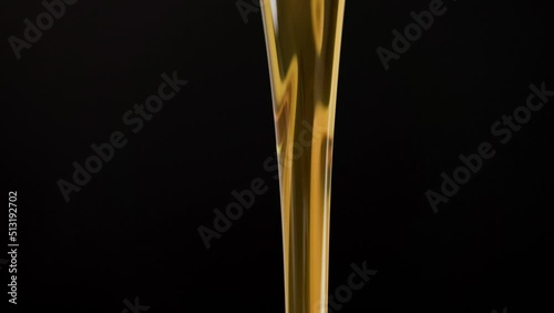 pouring motor oil from the golden plastic canister on black background. slow-motion close-up pouring engine oil in black background.