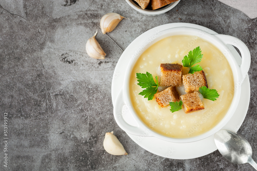 Cauliflower potato soup puree on stone background, Creamy cauliflower soup with toasted bread croutons.Vegetarian healthy food concept. Ideas and recipes for winter meal - obrazy, fototapety, plakaty 