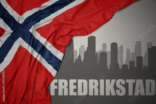Quadro em tela abstract silhouette of the city with text Fredrikstad near waving national flag of norway on a gray background