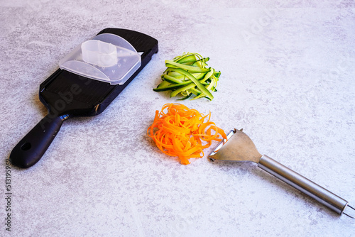 Vegetable slicer and peeler on white table  photo