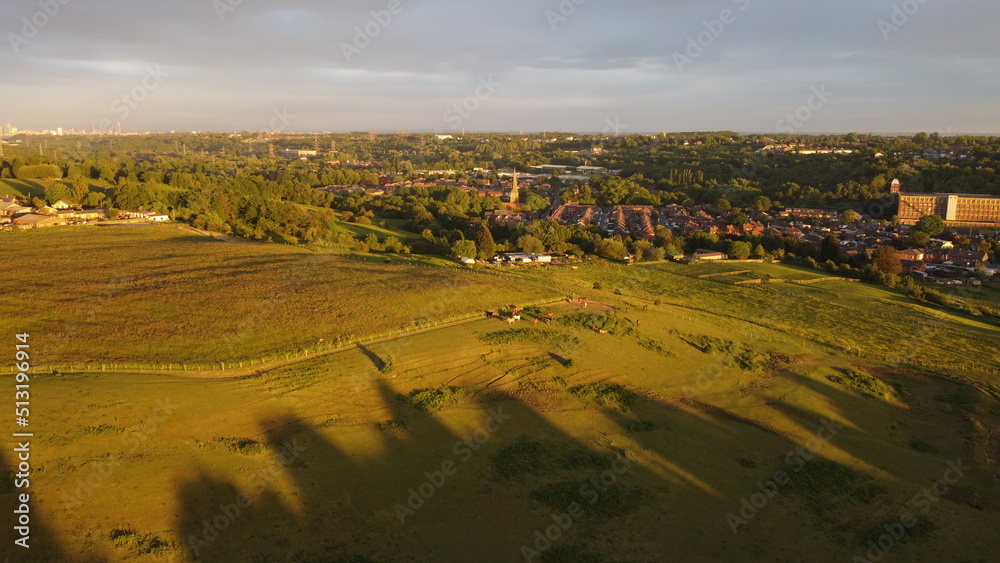 sunset city and horse view. drone shooting in green countryside