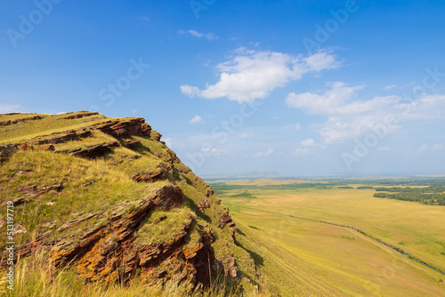 Sunny summer landscape of the Sunduki mountain range in Khakassia, Russia. Located in the valley of the Bely Iyus River.