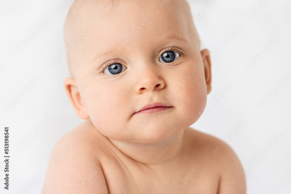 Close-up portrait of serious baby girl with blue eyes Close-up portrait of serious baby girl with blue eyes