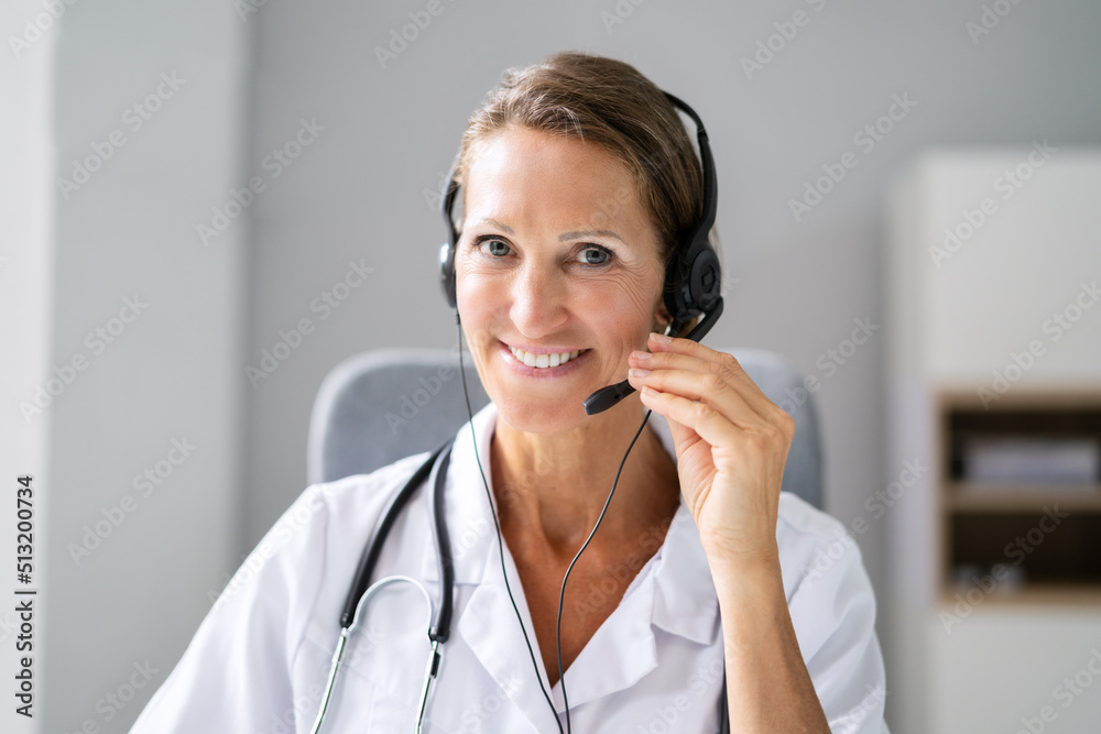 Confident Receptionist Using Headset In Hospital Confident Receptionist Using Headset In Hospital