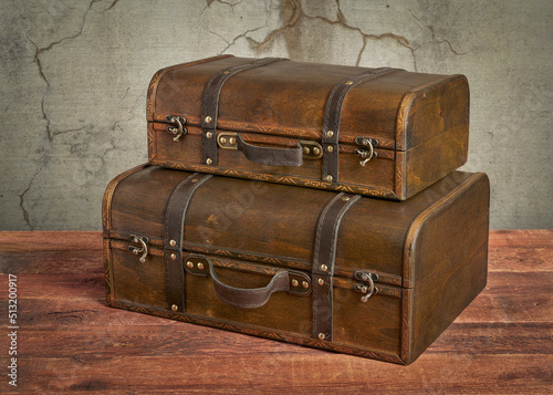 retro suitcase or storage box on wooden rustic table, set of two