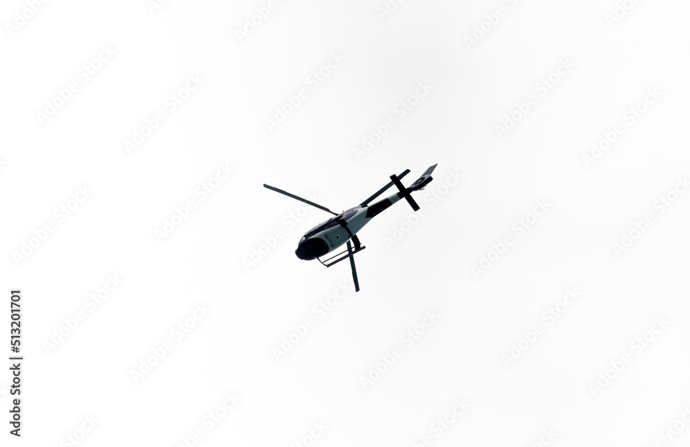 Helicopter Flying in the sky on a white background for design as a security concept and surveillance Helicopter Flying in the sky on a white background for design as a security concept and surveillance