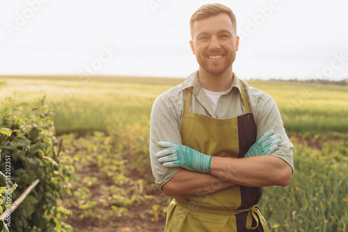 Portrait of a happy man farmer smiling in the garden