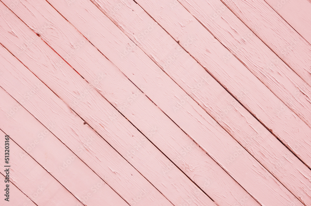 Pink painted boards. Abstract background of diagonally placed old wooden planks with cracked paint texture. Pink painted boards. Abstract background of diagonally placed old wooden planks with cracked paint texture.