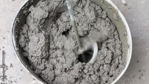 Mixing of concrete mortar.The builder prepares the cement mortar using a construction mixer.Plaster mortar in a bucket.