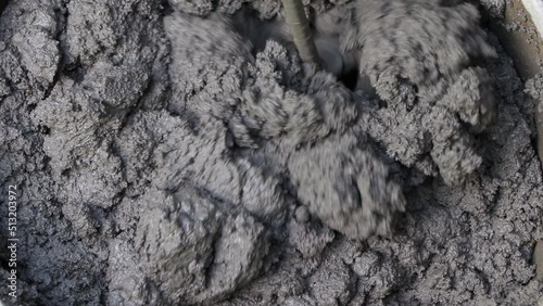Mixing of concrete mortar.The builder prepares the cement mortar using a construction mixer.Plaster mortar in a bucket.