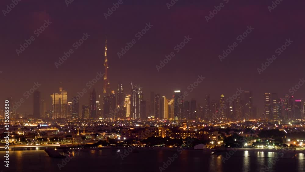 Aerial hyper-lapse helicopter view of Dubai Burj Khalifa building skyscraper and Dubai skyline at night Aerial hyper-lapse helicopter view of Dubai Burj Khalifa building skyscraper and Dubai skyline at night
