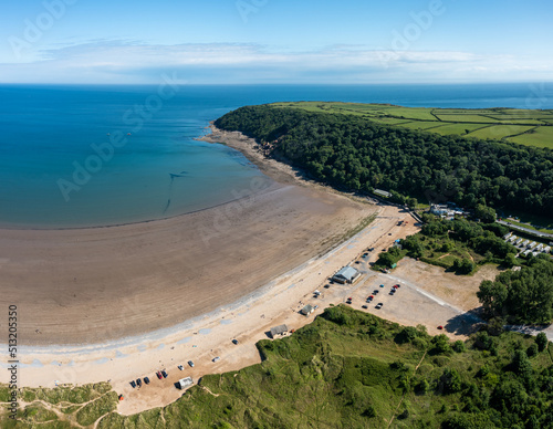 Oxwich Bay on the Gower peninsula in Swansea, UK, a long sweeping sandy bay with a shallow water line with easy access by road from Swansea attracts visitors from all over the UK