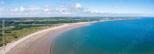 Oxwich Bay on the Gower peninsula in Swansea, UK, a long sweeping sandy bay with a shallow water line with easy access by road from Swansea attracts visitors from all over the UK