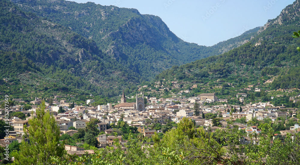 View of Soller Mallorca from above with Tramuntana mountains in the background.