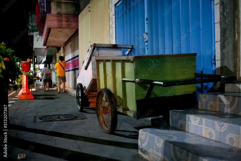 Street vendors cart in the sidewalk at night