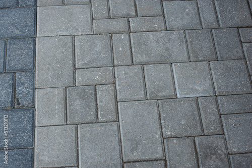 Paving slabs of different colors and shapes.Texture of different colored patterned paving slabs . Modern road surface.