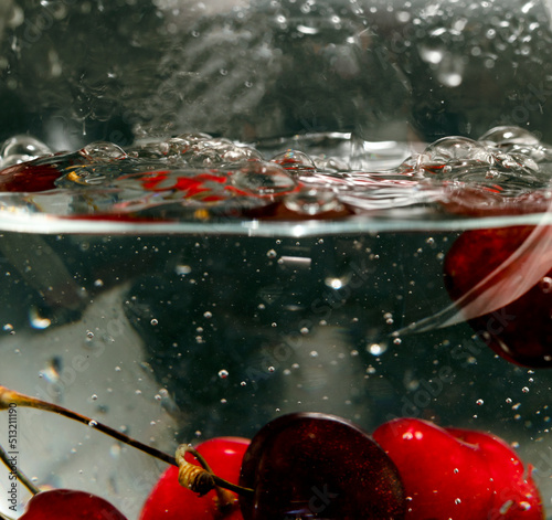 Cherries in a water bowl, close-up. water splash
