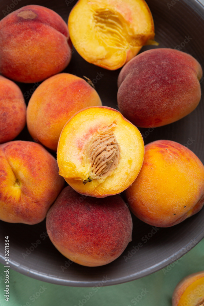 Overhead view of ripe organic peach in gray bowl fruits Overhead view of ripe organic peach in gray bowl fruits