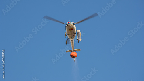 A helicopter collect water and fly to the mountains to put out a big fire in Pedrogão, Portugal