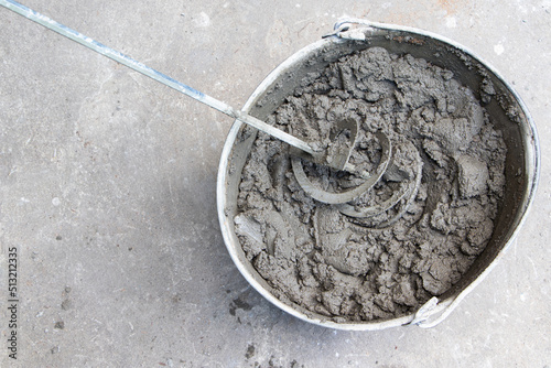 Mixing of concrete mortar.The builder prepares the cement mortar using a construction mixer.Plaster mortar in a bucket photo