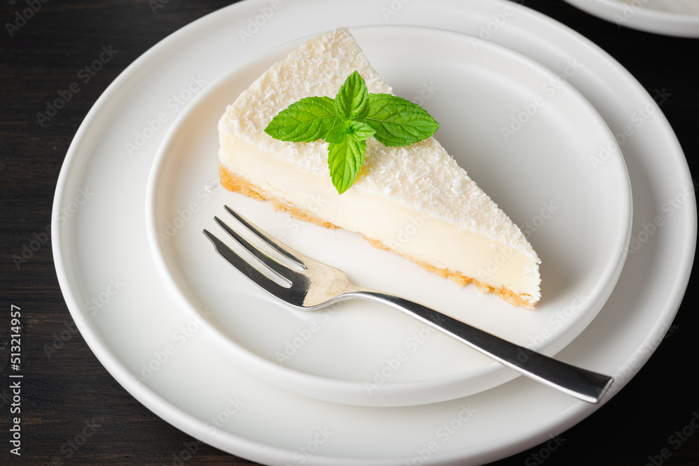 Cheesecake in a plate on a dark wooden table - obrazy, fototapety, plakaty 