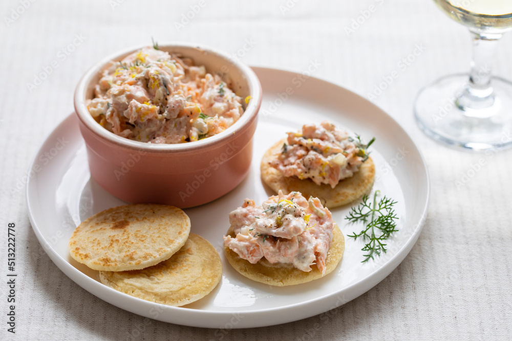 Party canapes, blinis with salmon spread Party canapes, blinis with salmon spread