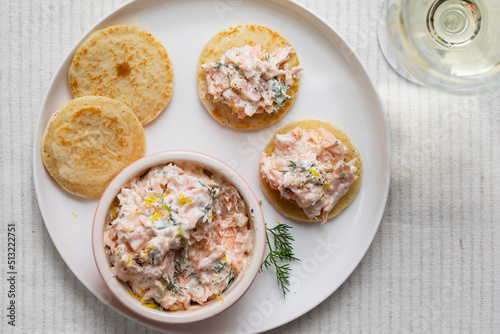 Party canapes, blinis with salmon spread photo